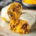 Taco Bell Beefy Melt Burrito wrapped in a flour tortilla with rice and beef filling.